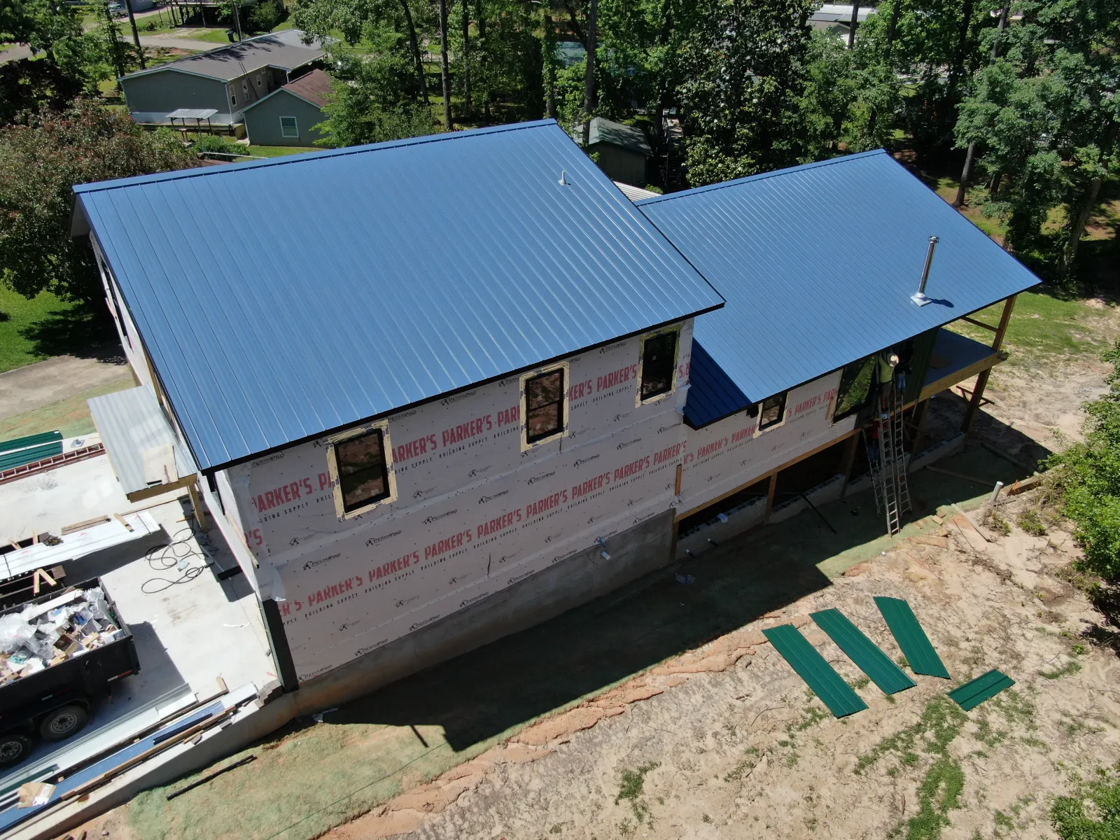 Blue metal roof on a new home under construction in East Texas