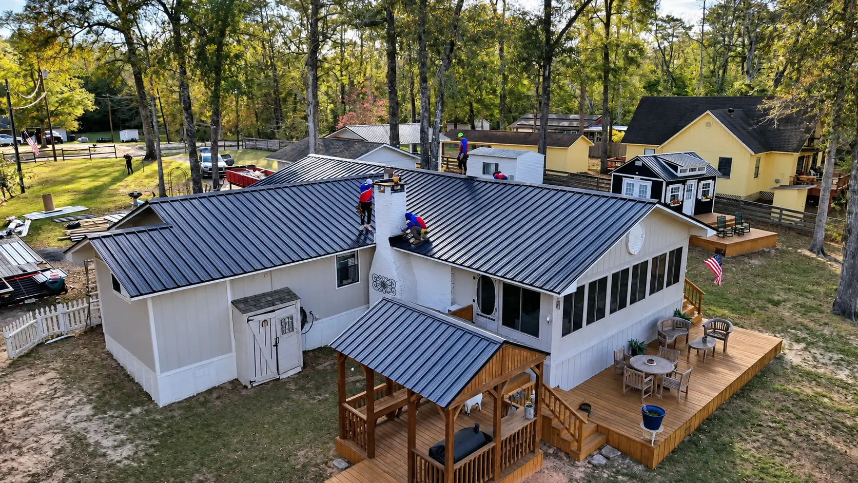 Aerial view of the crew finishing a metal roof on an East Texas home