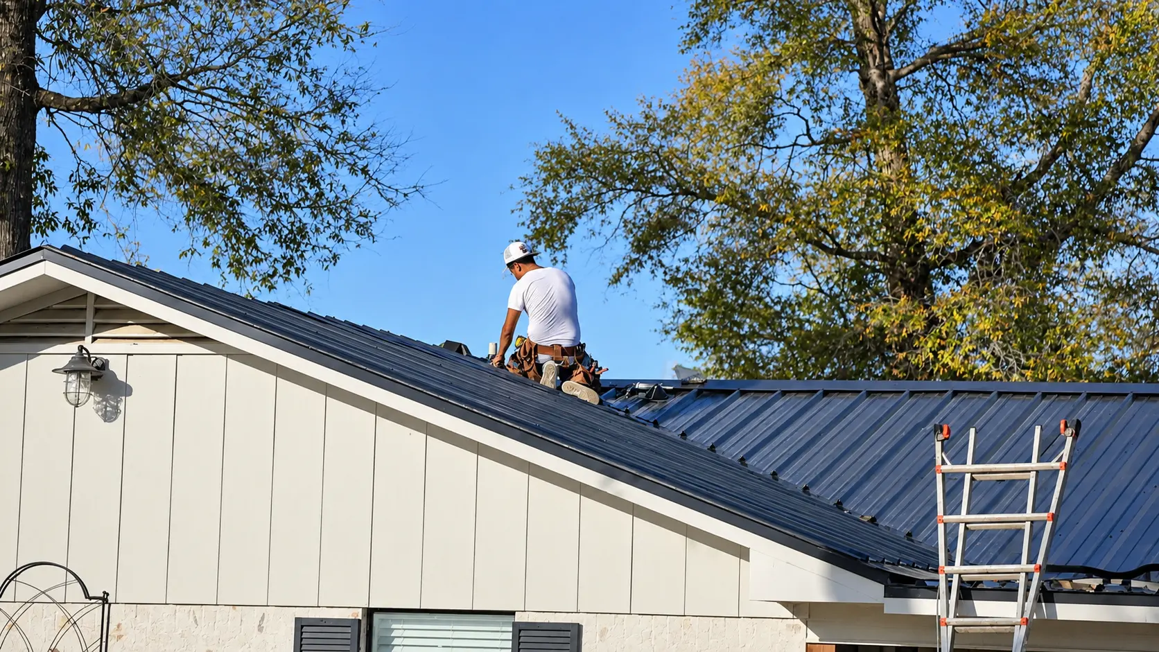 Roofer installing a black metal roof on an East Texas home